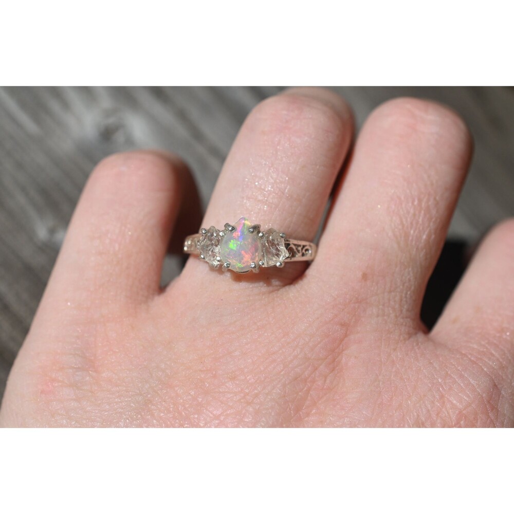 Brilliant opal ring, teardrop or pear shaped center stone with raw clear oval si
